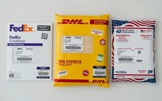 FedEx, DHL, and USPS international envelopes side by side